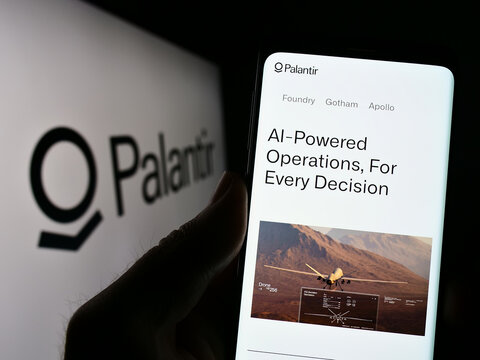 Stuttgart, Germany - 03-17-2023: Person holding cellphone with website of US analytics company Palantir Technologies Inc. on screen with logo. Focus on center of phone display.