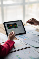 Two businessmen are reviewing monthly sales documents for analysis and marketing plans for more sales growth, they are the founders of young companies co-founding startups. Sales management concept.