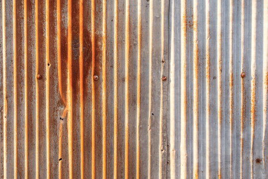 Wall aluminum silver stainless. Old, rusted zinc surface texture Gray galvanized iron wall texture, Zinc with rust pattern background Close up to pattern texture vertical zinc sheet Zinc vintage view.