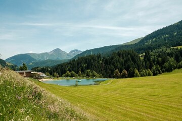 Obraz na płótnie Canvas Small lake in Disentis village, Sedrun, Switzerland, on a sunny summer day