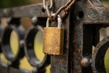 Rusty lock hanging on the bridge railings