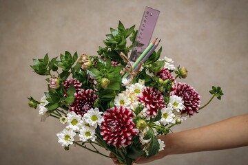 Closeup shot of a beautiful bouquet of flowers on the grey background