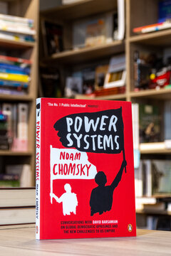 Close up Noam Chomsky and David Barsamian's Power Systems book in the bookshop. Stack of books.