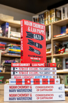 Close up Noam Chomsky and Ilan Pappé's Gaza in Crisis book in the bookshop. Stack of books.