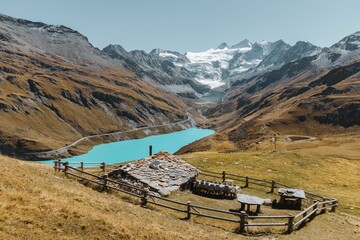 Swiss chalet in a meadow overlooking the Lake and Glacier of Moiry