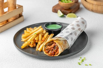 Mexican-style rolled tacos served with golden-brown French fries and a creamy dipping sauce