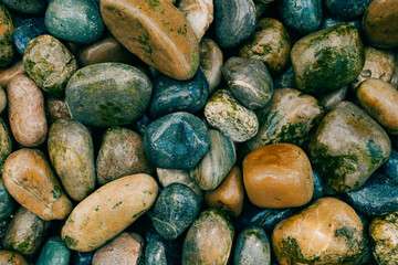 Colorful smooth stones on the shore. Backgroung with rocks