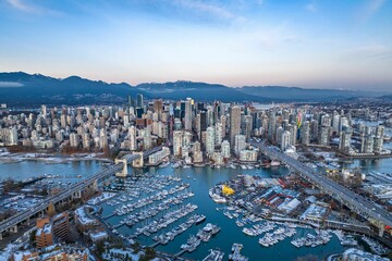 Fototapeta premium Aerial shot of the beautiful Vancouver city in Canada with many skyscrapers during the winter