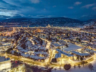 Drone shot of buildings in Kelowna, British Columbia, Canada in the evening