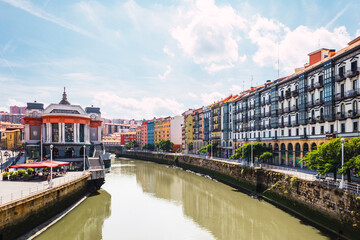 Bilbao city, the Ribera Market with Nervion river and its colorful architecture on a sunny day. Enjoying a nice vacation in the Basque Country, Spain