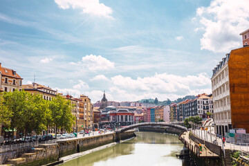 Fototapeta na wymiar Bilbao city with colorful architecture and the Nervion river on a sunny day. Enjoying a nice vacation in the Basque Country, Spain