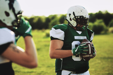 Football player holding a ball during practice