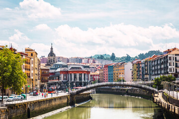 Bilbao city with the Ribera Market, the colorful architecture and the Nervion river on a sunny day. Enjoying a nice vacation in the Basque Country, Spain