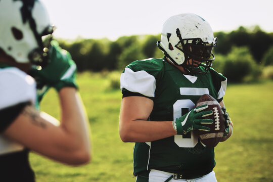 Football player holding a ball during practice