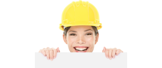 Construction worker engineer woman showing sign wearing yellow hard hat. Happy young woman holding peaking over white blank billboard card. Woman Isolated on transparent background in PNG cutout.