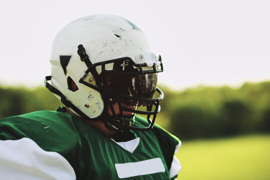 Football player wearing a helmet and visor outdoors