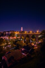Fototapeta na wymiar Vertical shot of a bridge in a city during nighttime