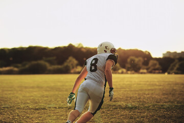 American football player running on a field during practice