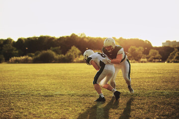American football player tackling a teammate during practice