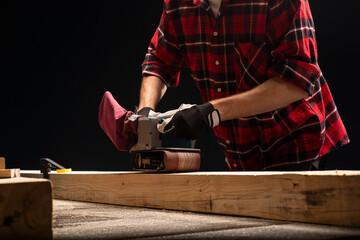 Carpenter works with electrical planer