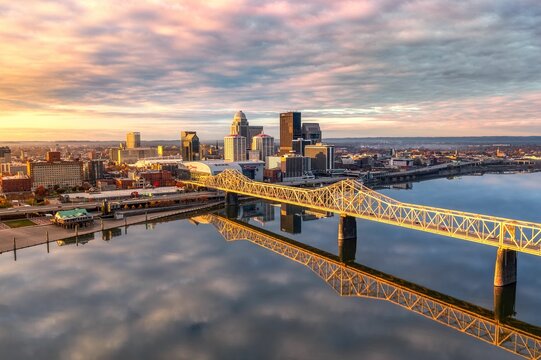 Aerial shot of the skyline of Louisville and the bridge at sunrise.