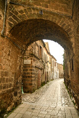 Fototapeta na wymiar Narrow street among the old stone houses of the oldest district of the city of Caserta