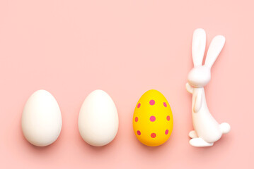 Happy Easter. Close-up of three easter eggs next to easter bunny with copy space for text