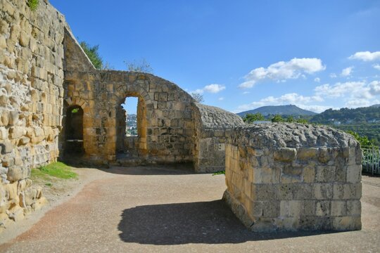 Arch in the ruins of Cuma, an ancient city near Naples with blue sky in the background