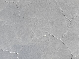 Fragment of an old wall, plaster, cracks close-up. Abstract background, template.