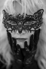 sad girl hides her face with a mask