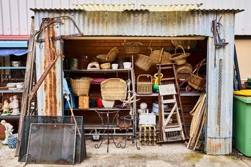 Wicker baskets, statues and old metal objects for sale in a small store