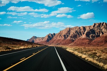 Straight desert road under blue sky on a sunny day in Arizona, United States