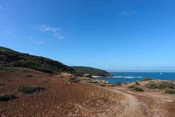 Aerial seascape with coastal rocky cliffs on a sunny day