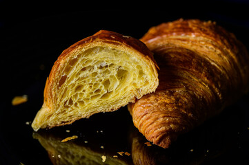 Freshly baked french croissant cut in half