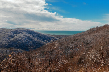 Mountain landscape under a blue sky. Snow-capped mountains under a blue sky on a sunny day. Snow-covered mountain landscape under a blue sky in winter.