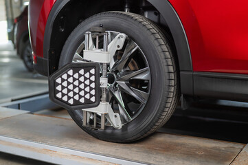 Alignment of car wheels in a car service.