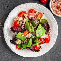 quinoa salad tomato, green leaf mix healthy meal food snack on the table copy space food background rustic top view 