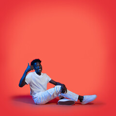 Cool black guy sitting on floor, showing thumb up