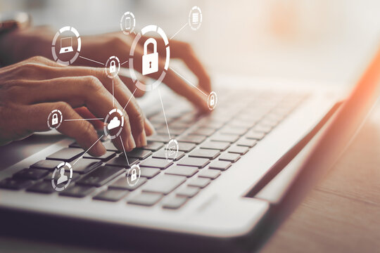 Business, technology, internet and networking concept. Young businesswoman working on his laptop in the office, select the icon security on the virtual display.