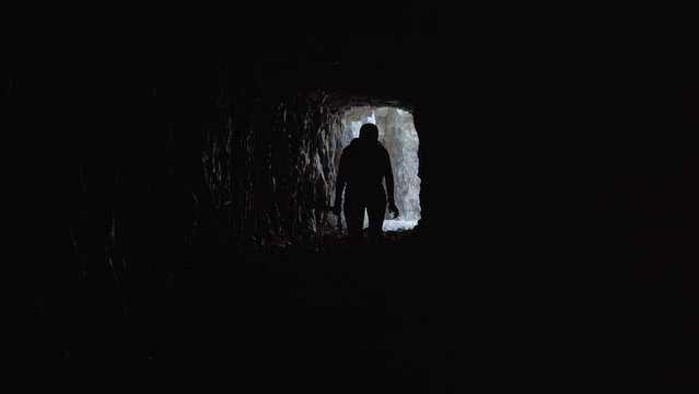 Girl walks inside a cave in the mountains