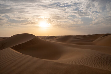 Sunset on the dunes in the empty quarter (desert), near Abu Dhabi in the United Arab Emirates.