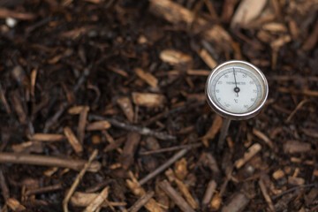 Immature compost managed in a community composter with one thermometer to control the process. Concept of recycling and sustainability