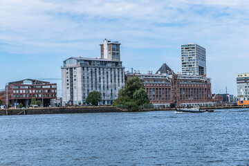 Fototapeta na wymiar Panoramic view from the IJ river to Western harbor area (Amsterdam-Noord borough), along the IJ river. AMSTERDAM, The NETHERLANDS.