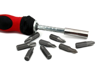 A screwdriver with a removable tip lies on a white isolated background.	