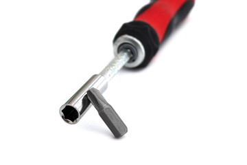 A screwdriver with a removable tip lies on a white isolated background.	