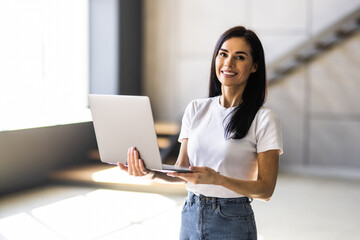 Beauitul young woman working using computer laptop concentrated
