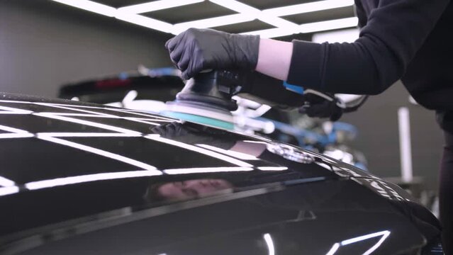 Professional car detailing using machinery and polishers for paint restoration.