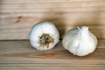 garlic on a wooden background, cooking with garlic as healthy spice, garlic as ingredient for healthy recipes for cooking