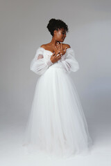 Happy african american woman in wedding dress. Fashion model in a white dress.