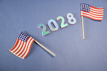 2028 Metallic Numbers with Mini American Flags on Blue Background